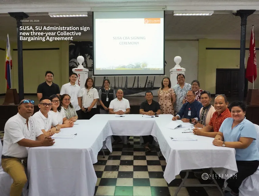 The eleven-members of the SUSA negotiating panel (seated) with representatives of the SU Administration (back) pose after the signing ceremony.